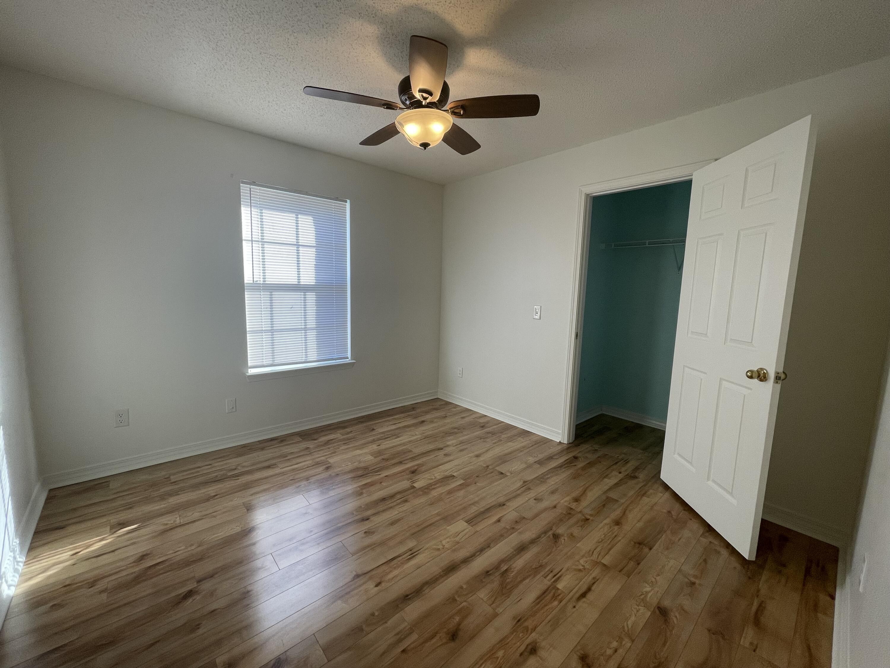 105 Steeplechase Drive Crestview, FL 32539 - Photo 11 of 14 a view of an empty room with wooden floor and a window