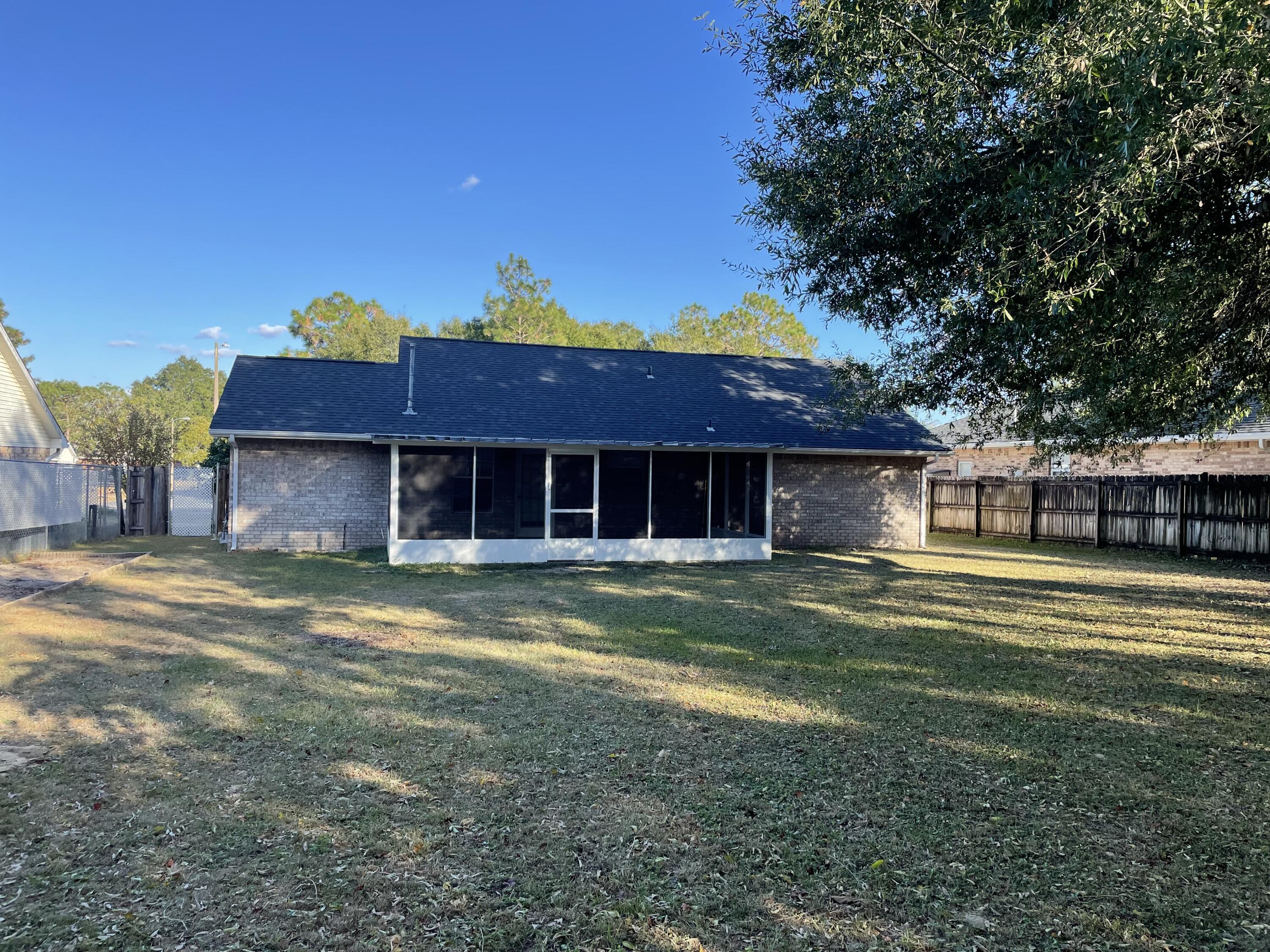 105 Steeplechase Drive Crestview, FL 32539 - Photo 14 of 14 a front view of a house with a garden