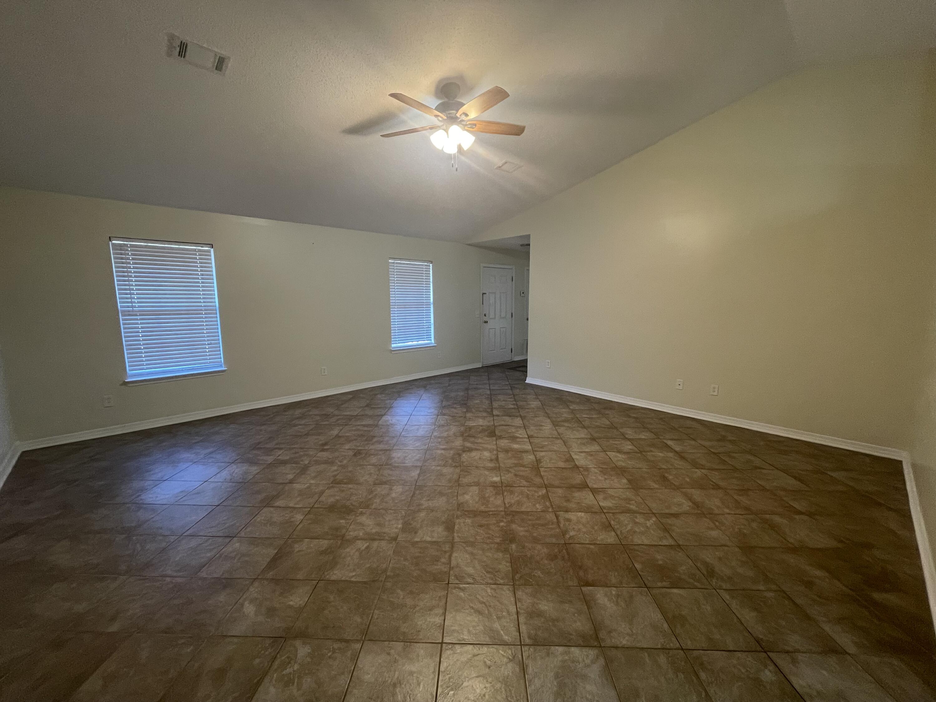 105 Steeplechase Drive Crestview, FL 32539 - Photo 5 of 14 an empty room with windows and fan view