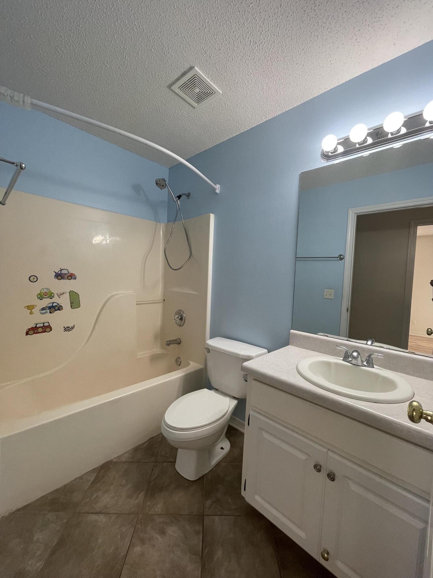 105 Steeplechase Drive Crestview, FL 32539 - Photo 10 of 14 a bathroom with a sink a toilet a mirror and bathtub