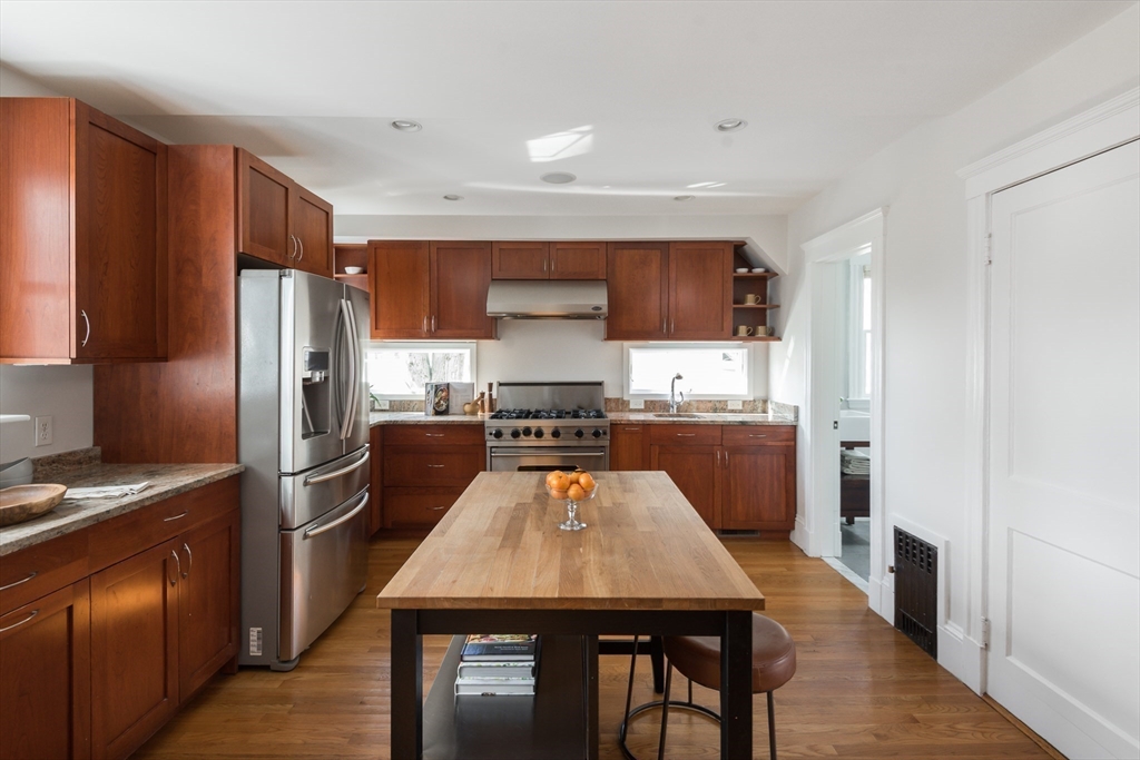 33 Ottawa Road Arlington, MA 02476 - Photo 13 of 38 a kitchen with a refrigerator a stove top oven a sink and cabinets