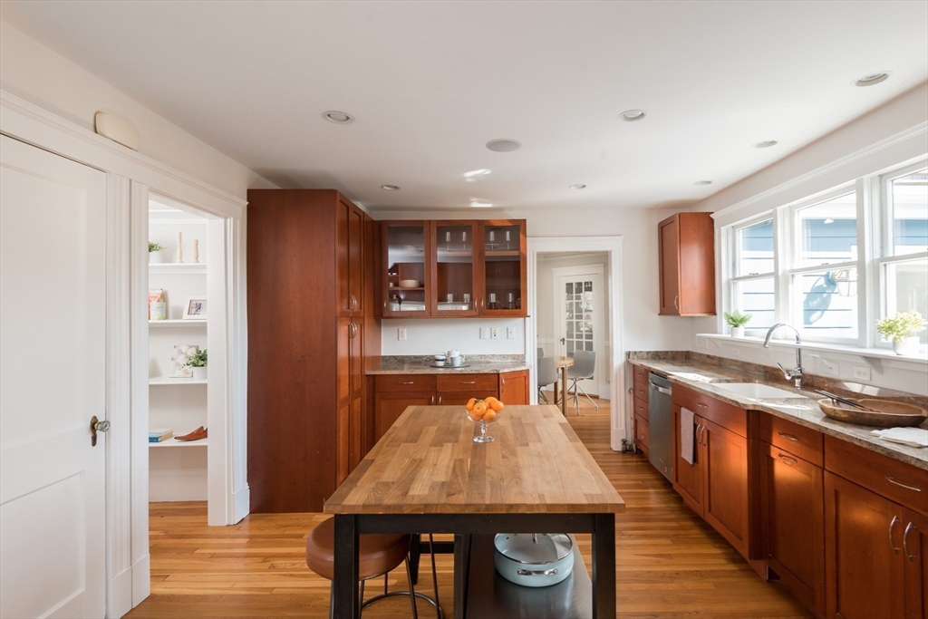 33 Ottawa Road Arlington, MA 02476 - Photo 15 of 38 a large kitchen with lots of counter space and wooden floor