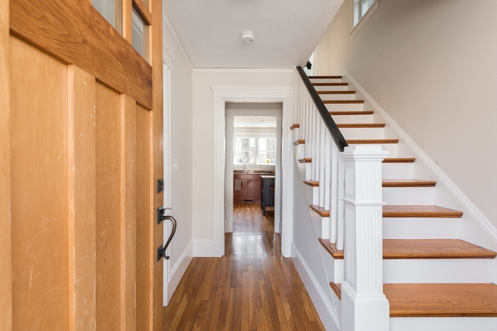 33 Ottawa Road Arlington, MA 02476 - Photo 2 of 38 a view of a hallway with wooden floor and staircase