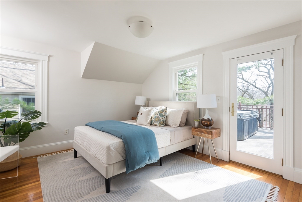 33 Ottawa Road Arlington, MA 02476 - Photo 21 of 38 a bedroom with a bed and potted plant next to a window