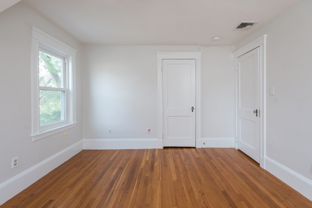 33 Ottawa Road Arlington, MA 02476 - Photo 27 of 38 an empty room with wooden floor and windows