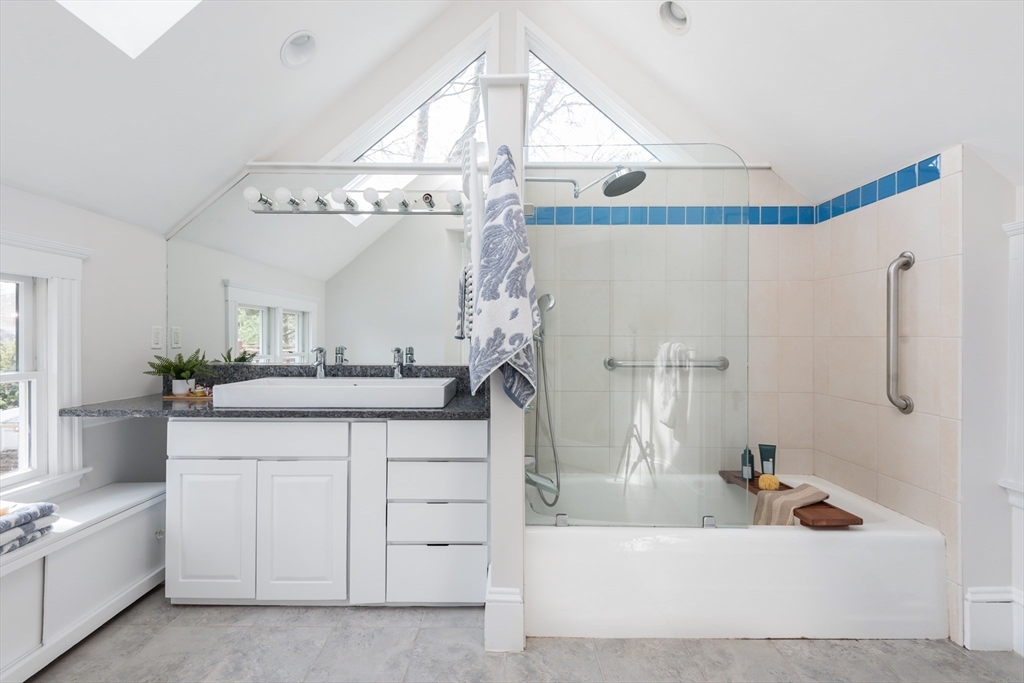 33 Ottawa Road Arlington, MA 02476 - Photo 28 of 38 a bathroom with a sink a mirror and a bathtub