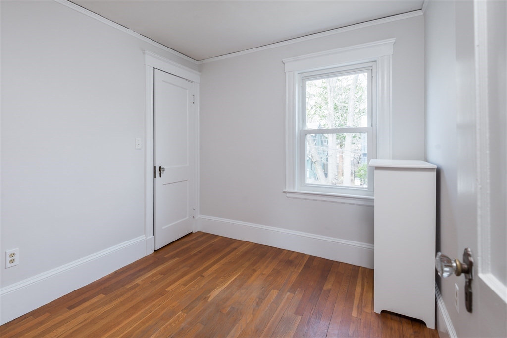 33 Ottawa Road Arlington, MA 02476 - Photo 30 of 38 an empty room with wooden floor and windows