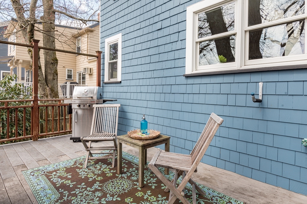 33 Ottawa Road Arlington, MA 02476 - Photo 6 of 38 a view of a patio with table and chairs and wooden fence