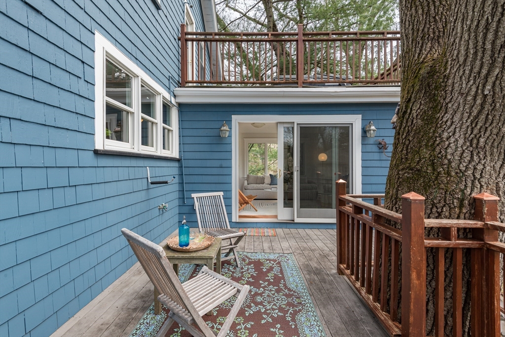 33 Ottawa Road Arlington, MA 02476 - Photo 7 of 38 a view of a house with a chairs and wooden fence