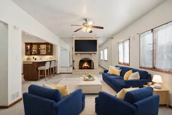 a living room with furniture a fireplace and a flat screen tv