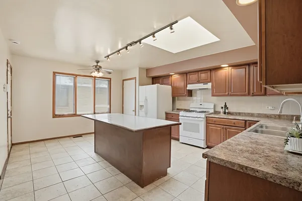 a kitchen with a sink window and cabinets