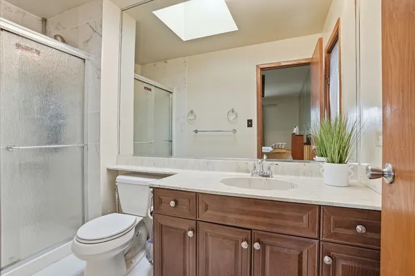 a bathroom with a sink toilet and shower