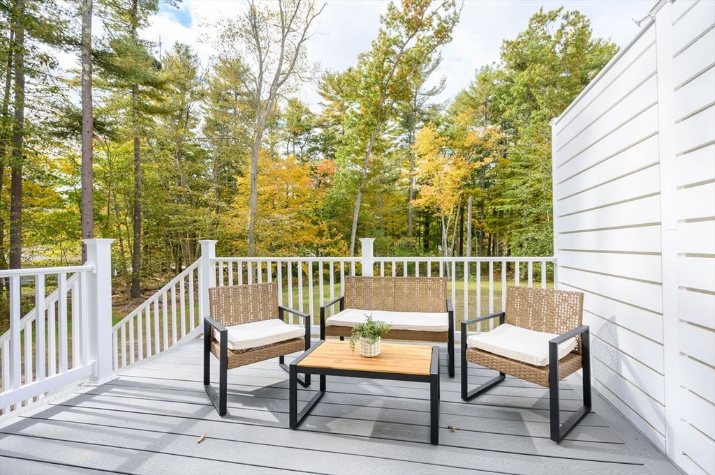 20 Howland Trail, Unit 35 Hanson, MA 02341 - Photo 11 of 26 a view of a chair and table on the deck