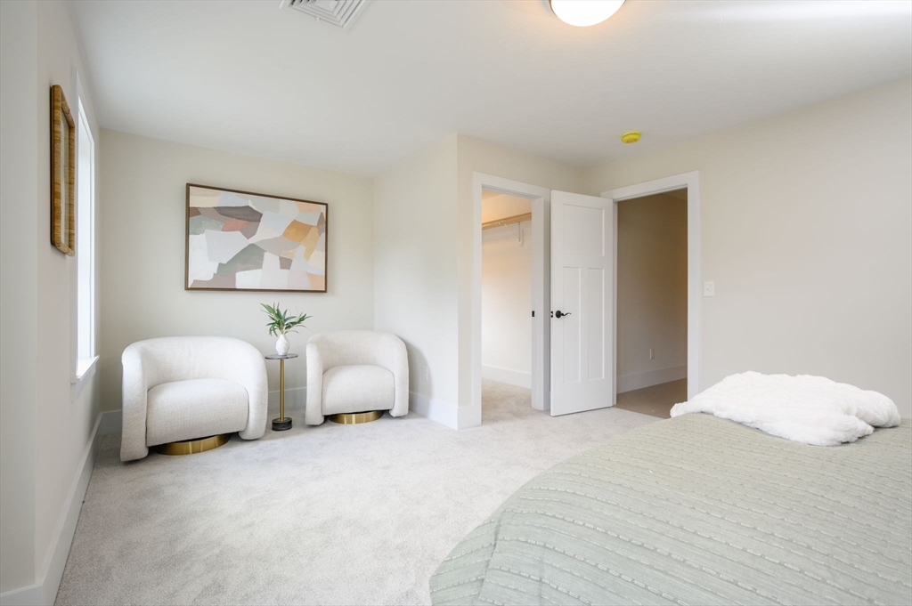 20 Howland Trail, Unit 35 Hanson, MA 02341 - Photo 3 of 26 a bedroom with bed and a couch