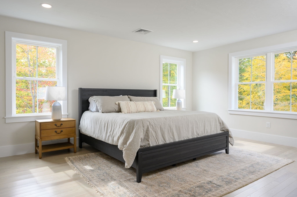 20 Howland Trail, Unit 35 Hanson, MA 02341 - Photo 4 of 26 a bed sitting in a bedroom next to a window