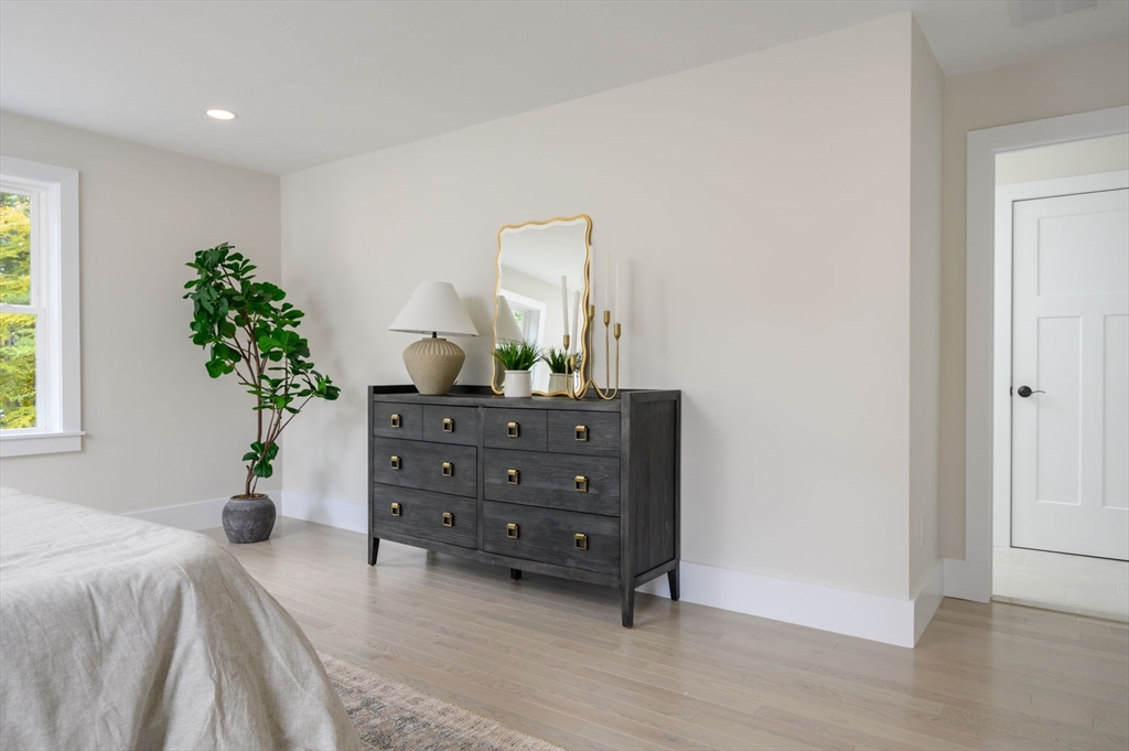 20 Howland Trail, Unit 35 Hanson, MA 02341 - Photo 5 of 26 a bedroom with a bed and a potted plant
