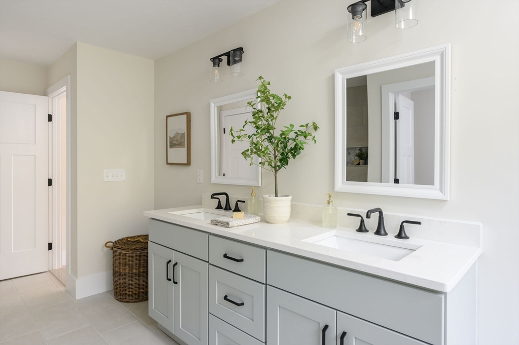 20 Howland Trail, Unit 35 Hanson, MA 02341 - Photo 10 of 26 a bathroom with double sink and a mirror