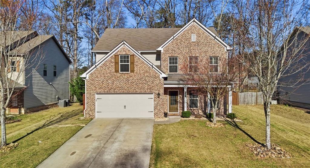 2495 Matlin Way Buford, GA 30519 - Photo 1 of 36 a view of a white house with large windows next to a yard
