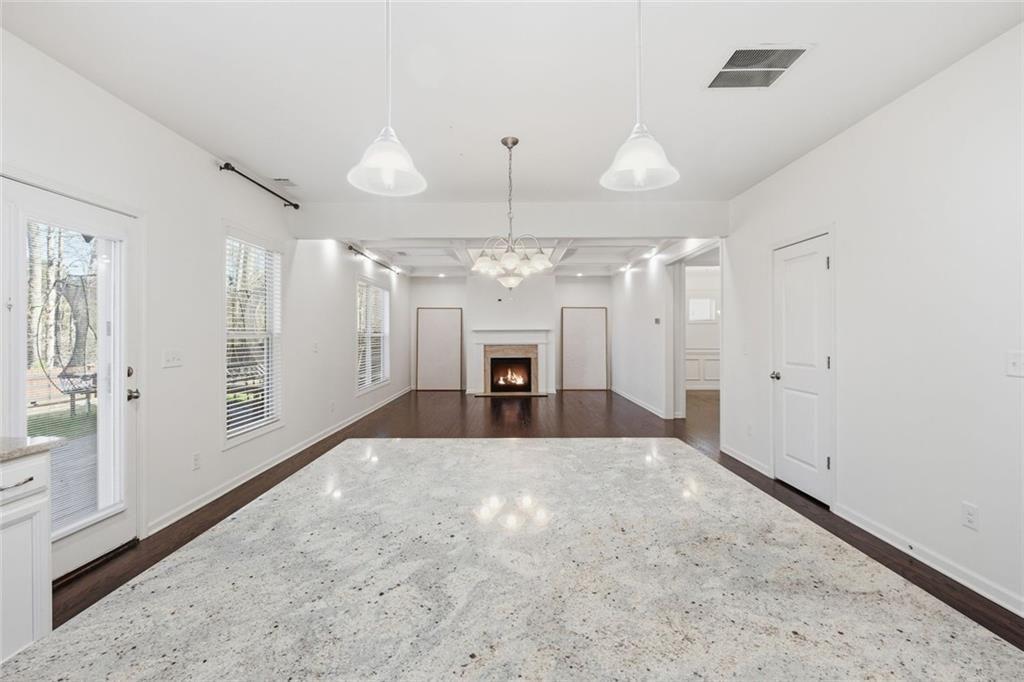 2495 Matlin Way Buford, GA 30519 - Photo 15 of 36 a large room with chandelier fan and windows