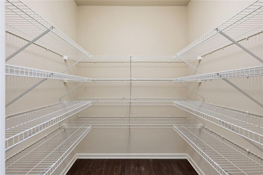 2495 Matlin Way Buford, GA 30519 - Photo 17 of 36 a view of walk in closet with empty racks