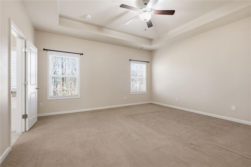 2495 Matlin Way Buford, GA 30519 - Photo 20 of 36 an empty room with windows and fan