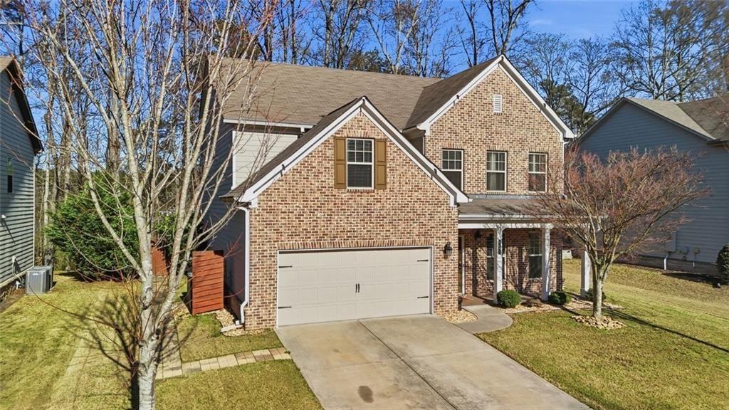 2495 Matlin Way Buford, GA 30519 - Photo 2 of 36 front view of house with a yard