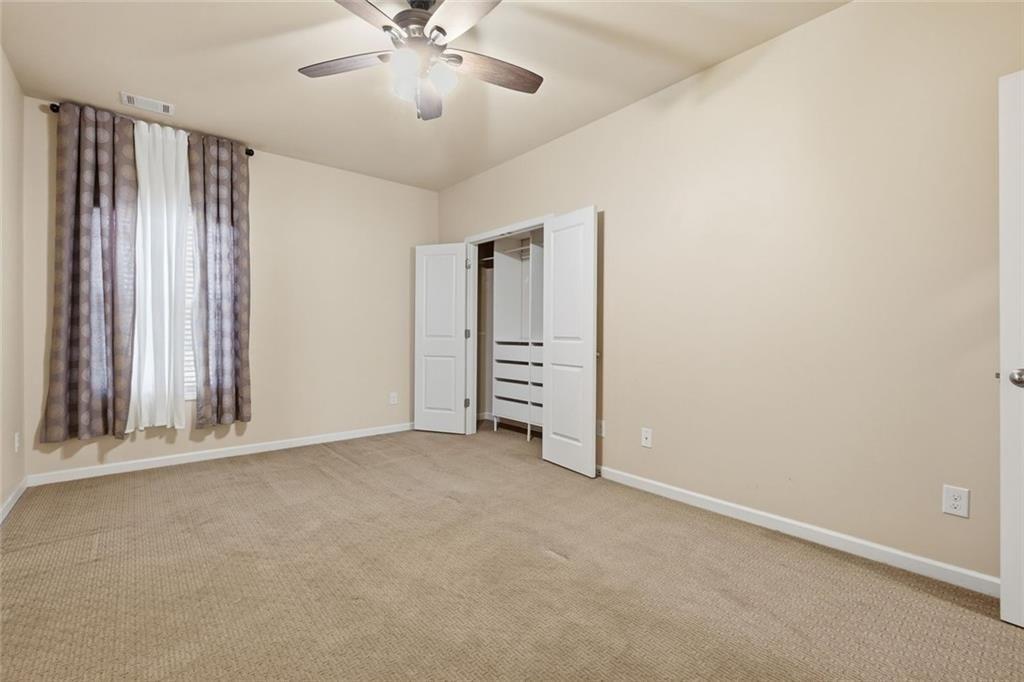 2495 Matlin Way Buford, GA 30519 - Photo 26 of 36 an empty room with windows and closet