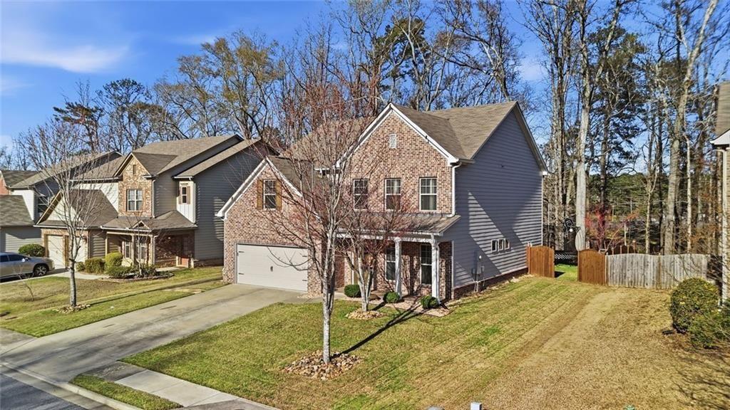 2495 Matlin Way Buford, GA 30519 - Photo 3 of 36 a view of a house with a small yard and large tree