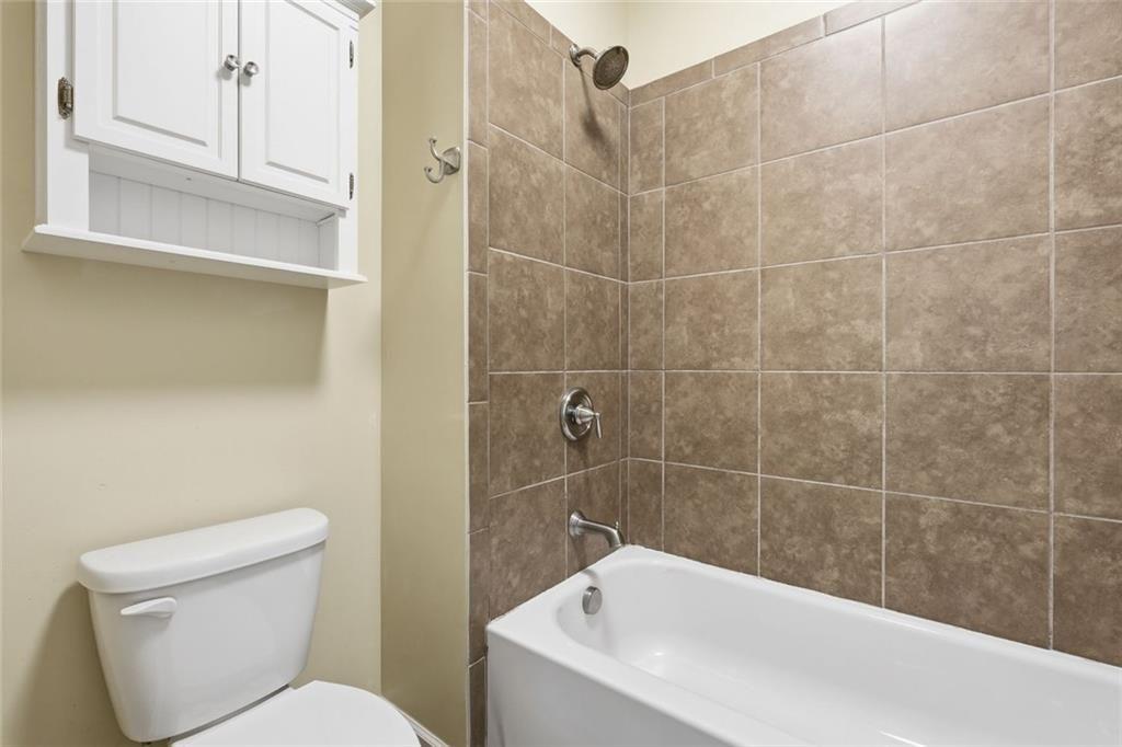 2495 Matlin Way Buford, GA 30519 - Photo 32 of 36 a bathroom with a toilet and bathtub