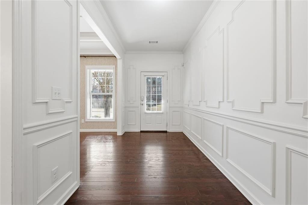 2495 Matlin Way Buford, GA 30519 - Photo 5 of 36 an empty room with wooden floor and windows