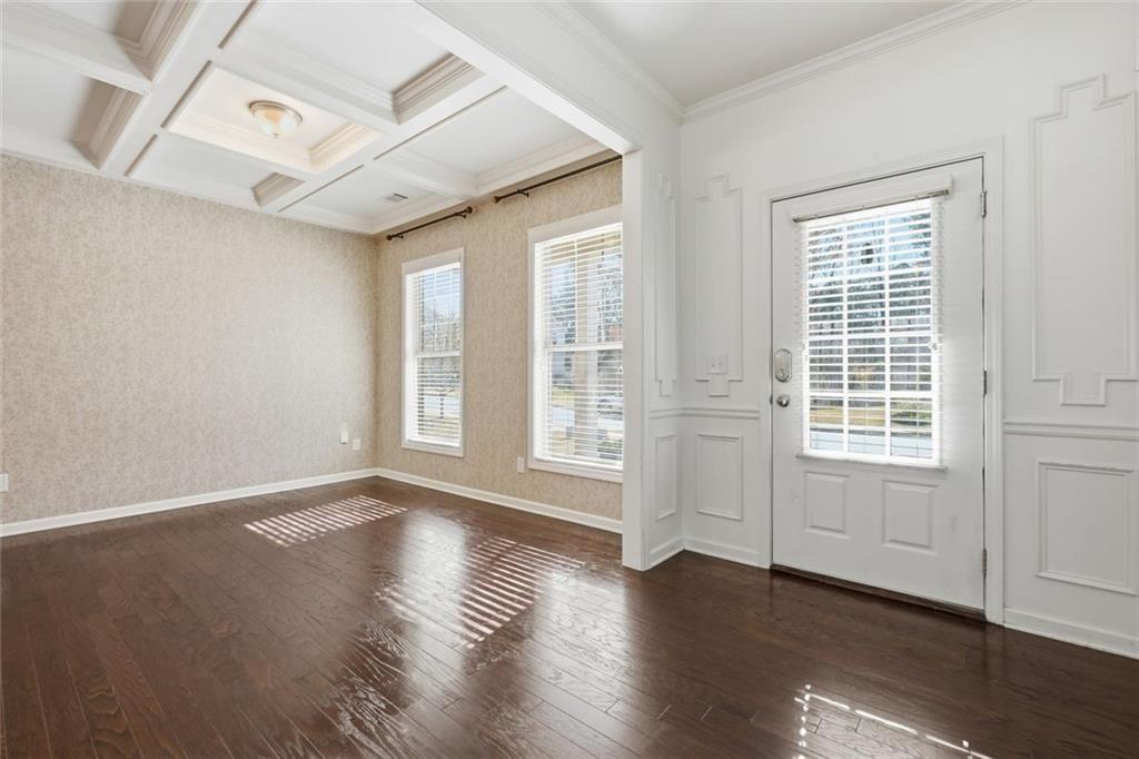 2495 Matlin Way Buford, GA 30519 - Photo 7 of 36 a view of an empty room with wooden floor and a window