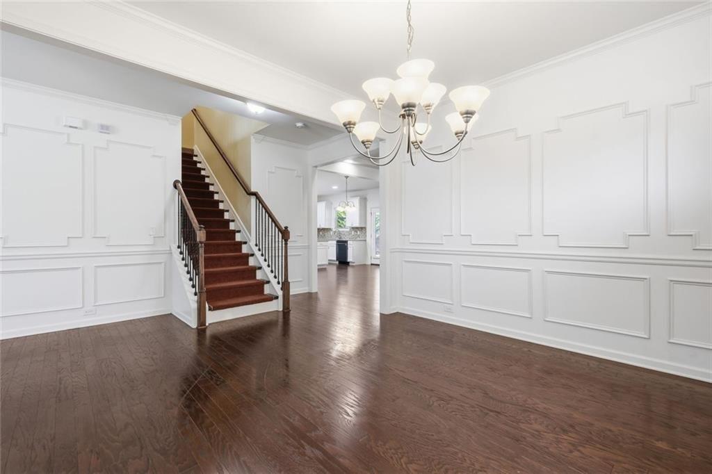 2495 Matlin Way Buford, GA 30519 - Photo 9 of 36 a view of an empty room with wooden floor and staircase