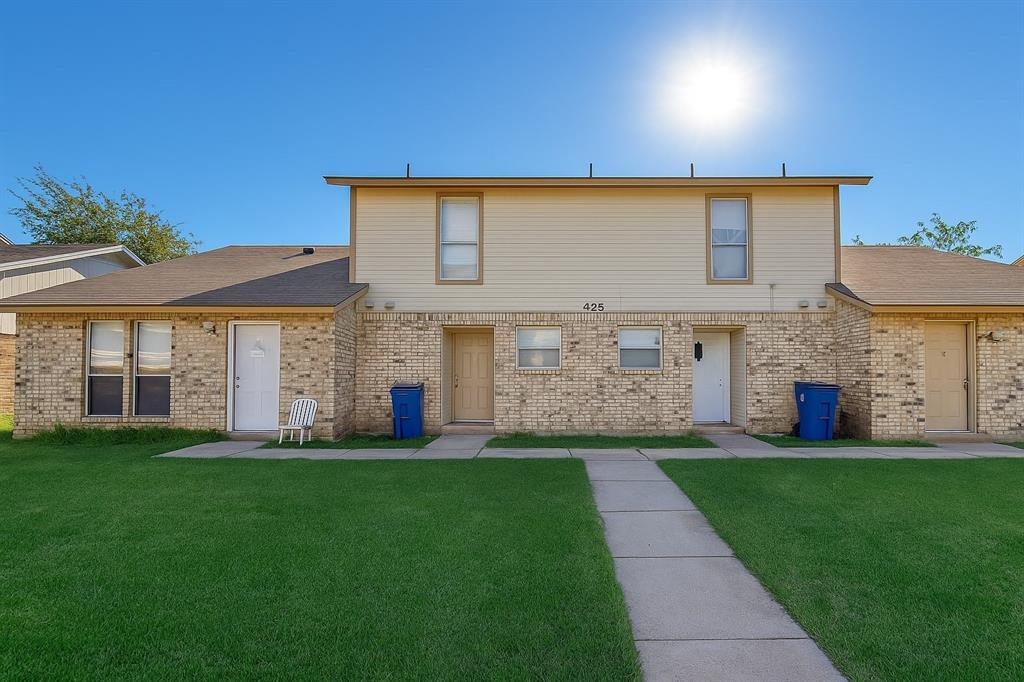 425 Southwest Thomas Street, Unit B Burleson, TX 76028 - Photo 1 of 22 a large house with a yard