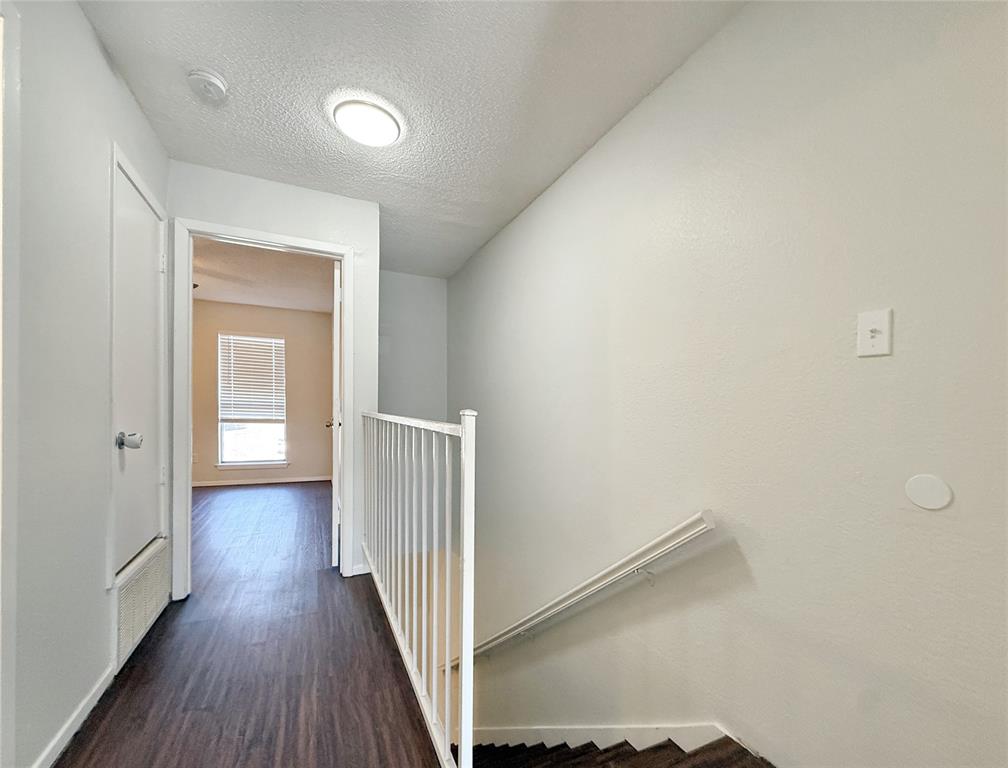 425 Southwest Thomas Street, Unit B Burleson, TX 76028 - Photo 12 of 22 a view of a hallway with wooden floor