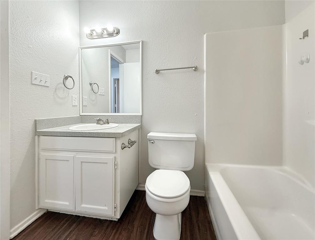 425 Southwest Thomas Street, Unit B Burleson, TX 76028 - Photo 17 of 22 a bathroom with a sink a toilet and shower