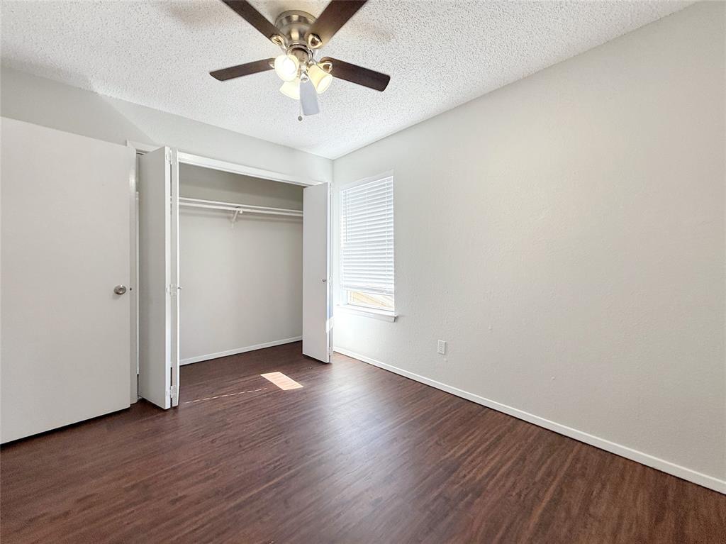 425 Southwest Thomas Street, Unit B Burleson, TX 76028 - Photo 21 of 22 a view of an empty room with wooden floor