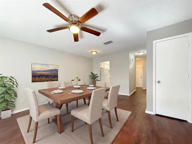 a dining room with furniture and wooden floor