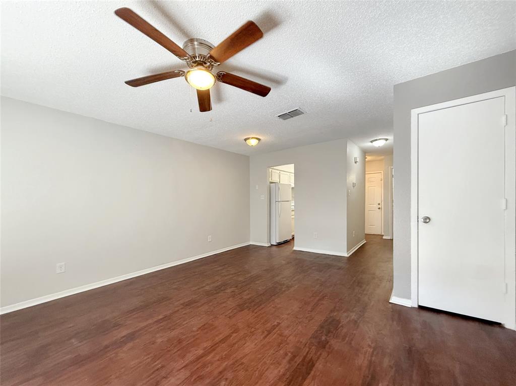 425 Southwest Thomas Street, Unit B Burleson, TX 76028 - Photo 5 of 22 a view of an empty room with wooden floor