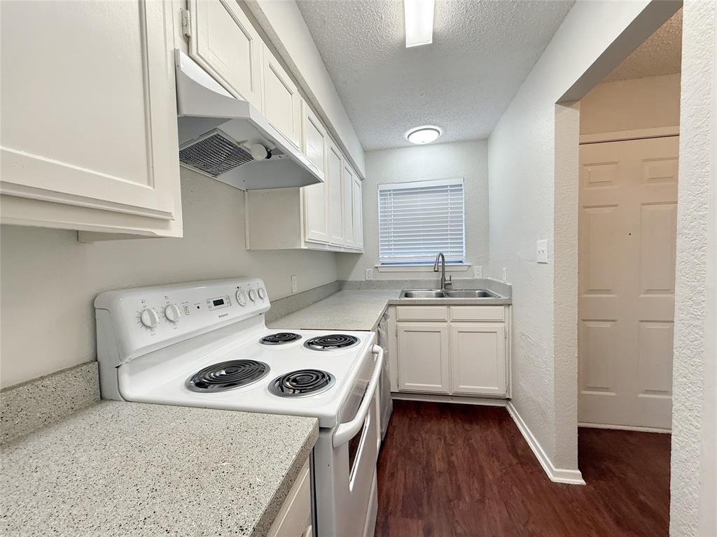 425 Southwest Thomas Street, Unit B Burleson, TX 76028 - Photo 6 of 22 a kitchen with a sink a stove and a refrigerator