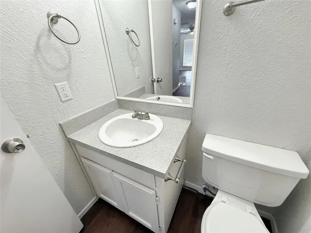 a bathroom with a sink a toilet and a mirror