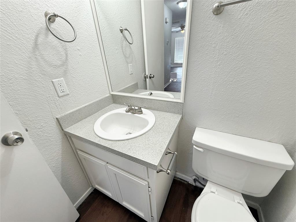 425 Southwest Thomas Street, Unit B Burleson, TX 76028 - Photo 8 of 22 a bathroom with a sink a toilet and a mirror