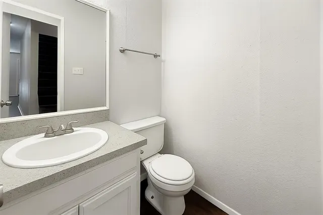 a bathroom with a sink a toilet and mirror