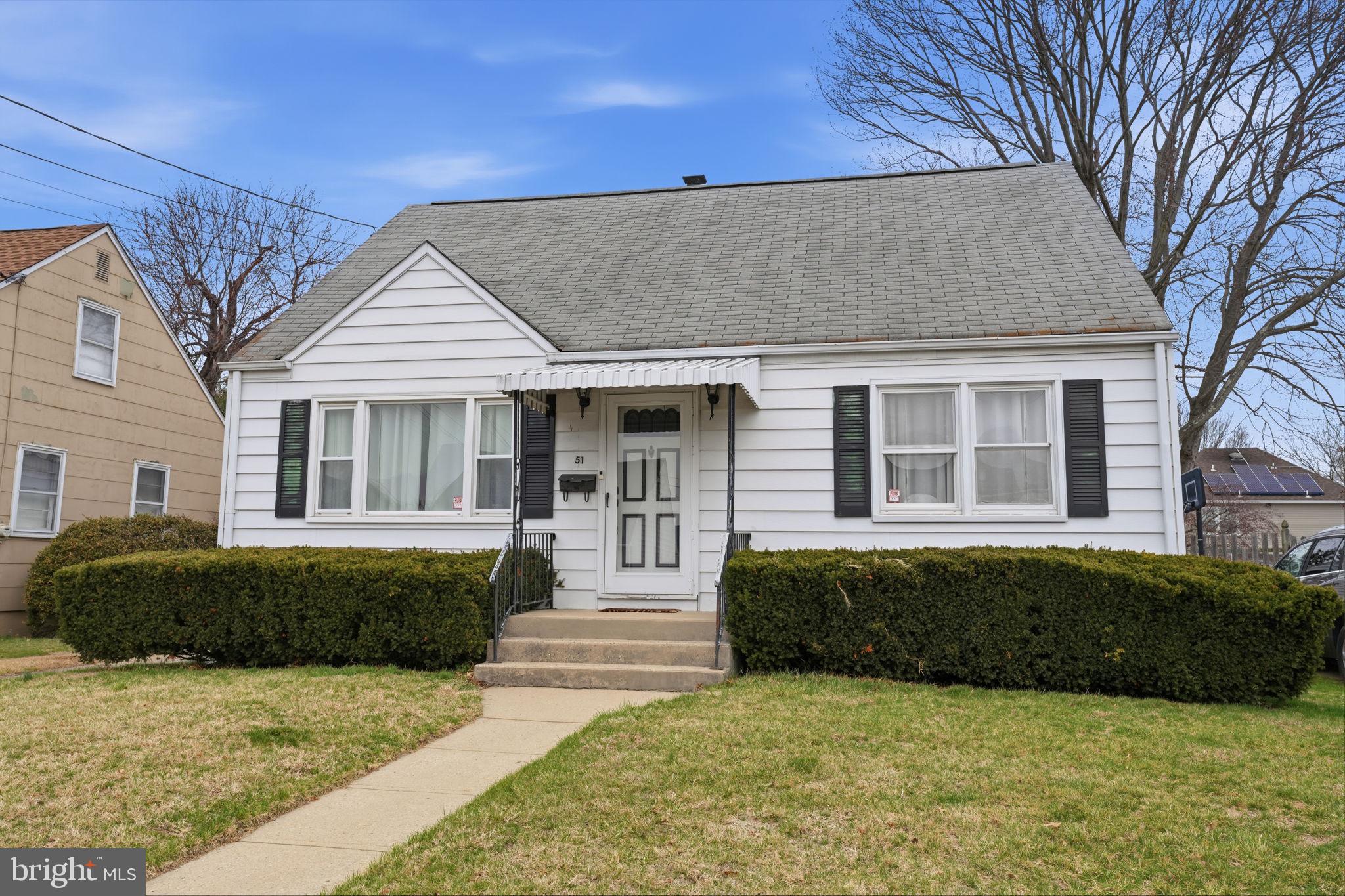 51 Unwin Drive Hamilton, NJ 08610 - Photo 1 of 32 a front view of a house with a garden