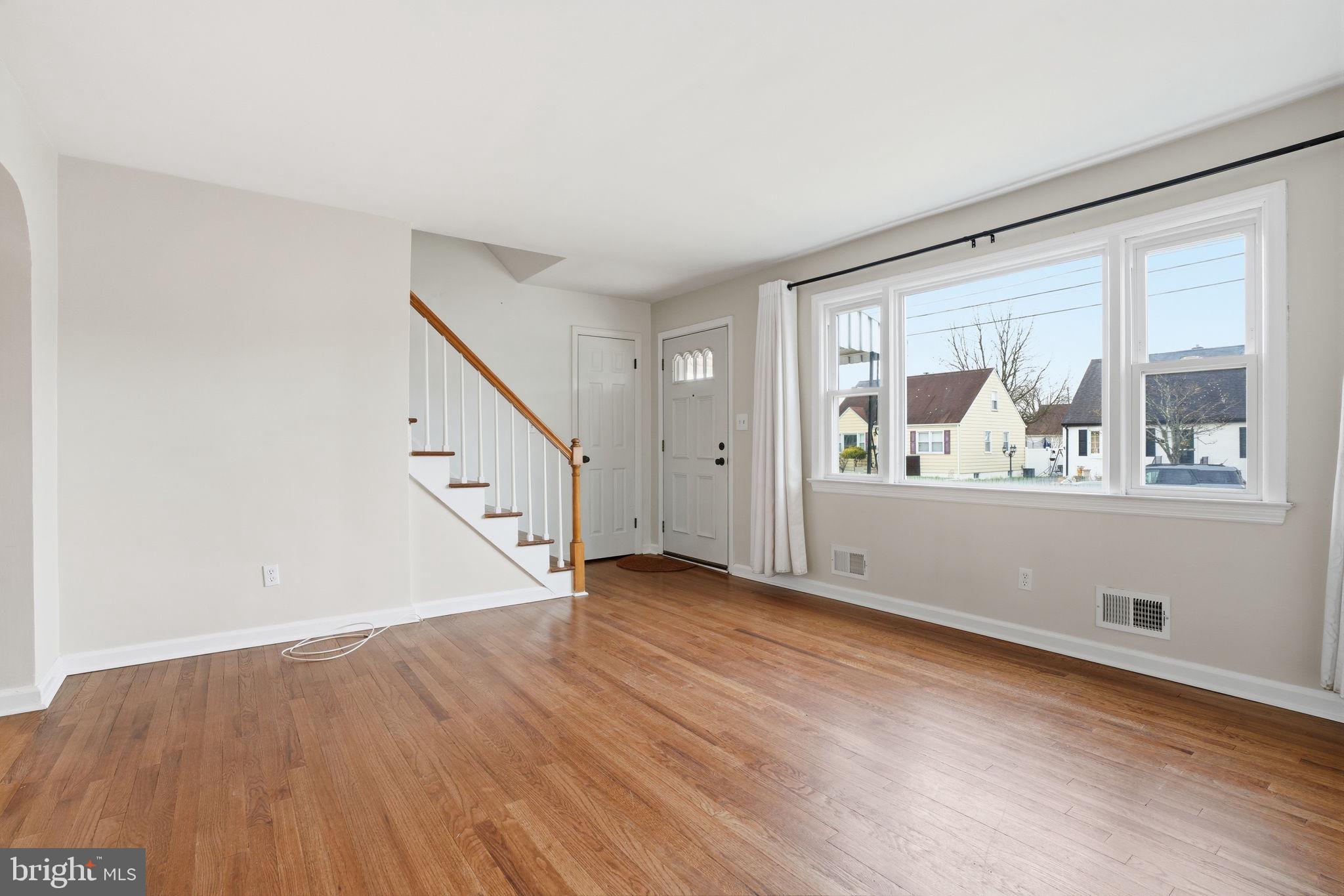 51 Unwin Drive Hamilton, NJ 08610 - Photo 12 of 32 a view of an empty room with wooden floor and a window