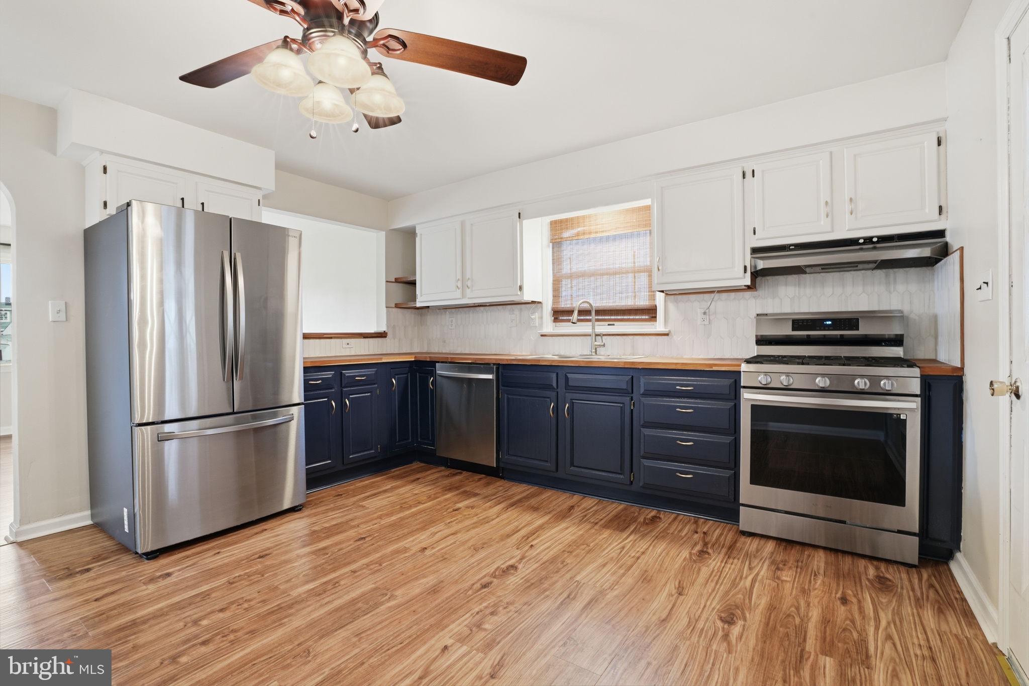 51 Unwin Drive Hamilton, NJ 08610 - Photo 14 of 32 a kitchen with stainless steel appliances granite countertop a refrigerator and a stove top oven