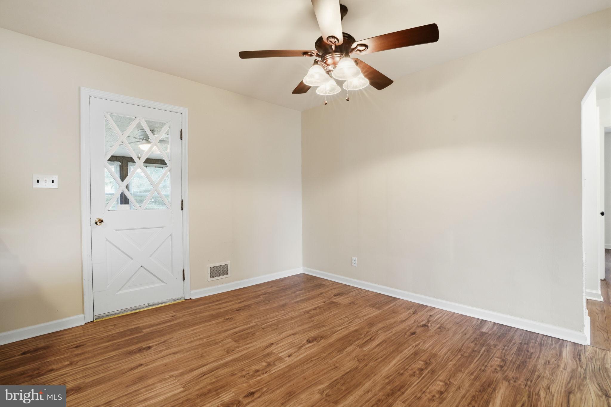 51 Unwin Drive Hamilton, NJ 08610 - Photo 16 of 32 an empty room with wooden floor ceiling fan and windows