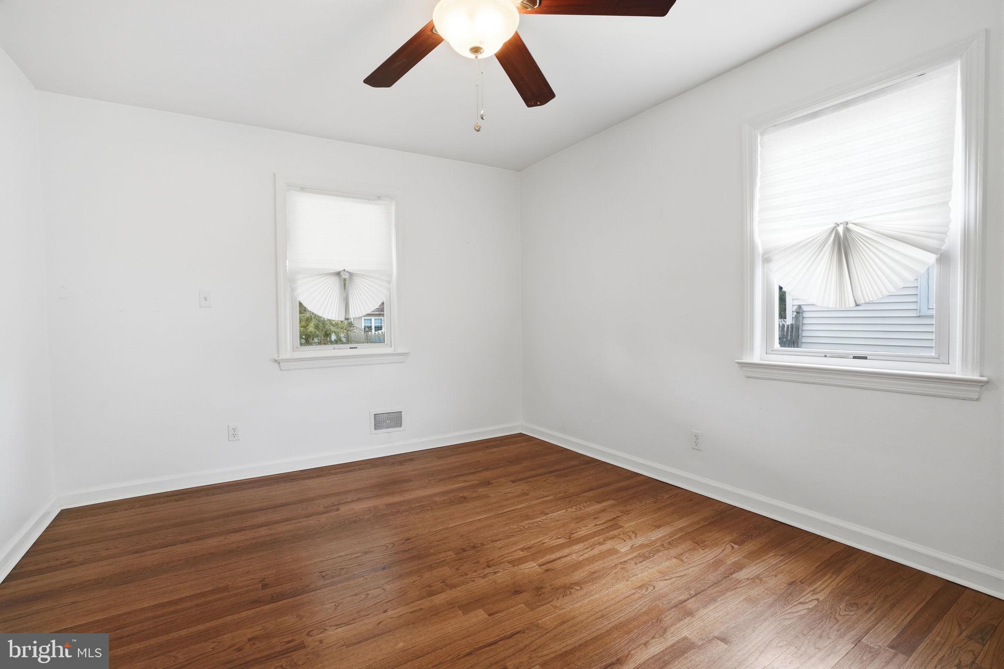 51 Unwin Drive Hamilton, NJ 08610 - Photo 19 of 32 an empty room with wooden floor and windows