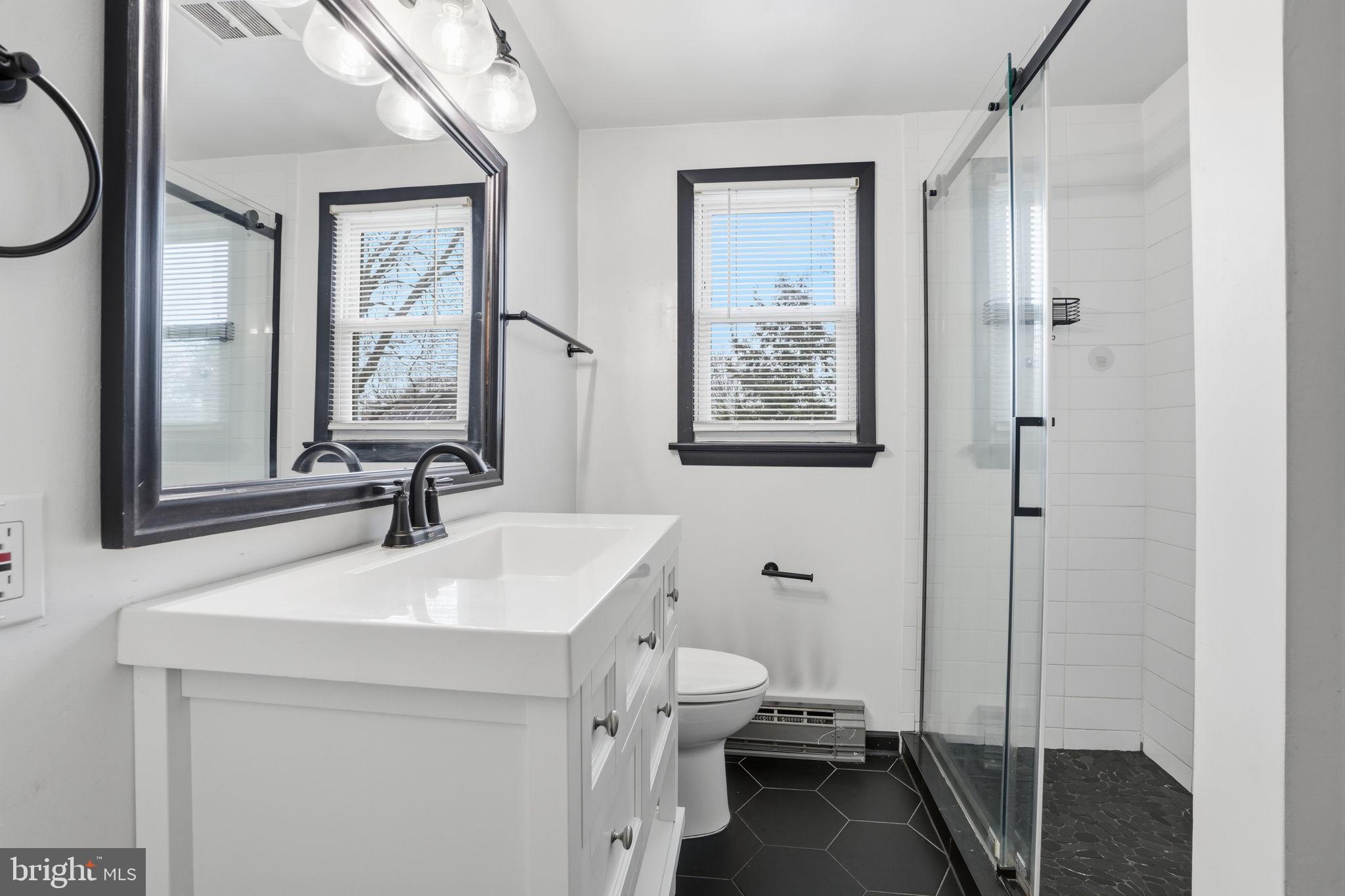 51 Unwin Drive Hamilton, NJ 08610 - Photo 20 of 32 a bathroom with a sink a toilet and a mirror