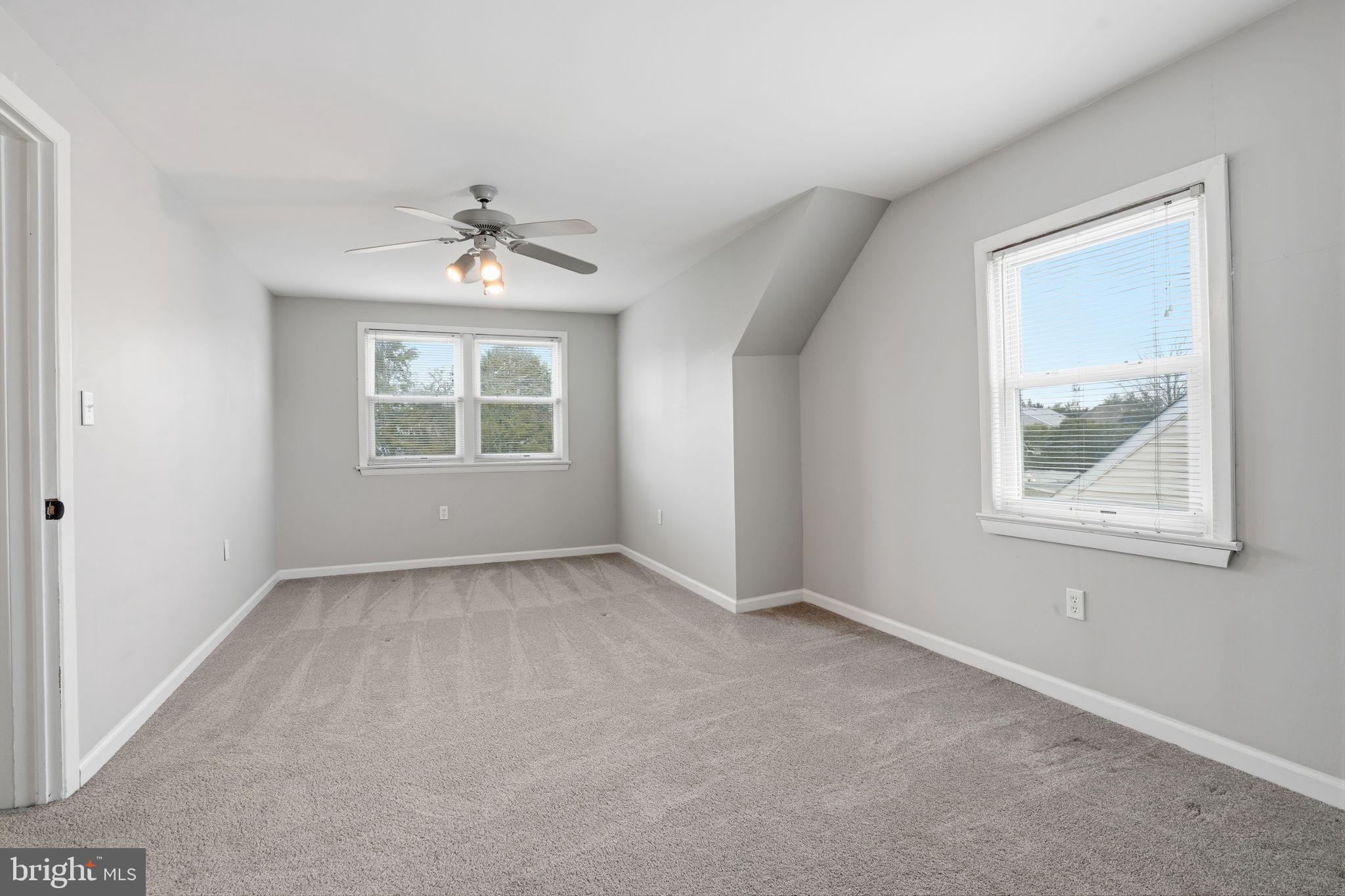 51 Unwin Drive Hamilton, NJ 08610 - Photo 26 of 32 an empty room with windows and chandelier fan
