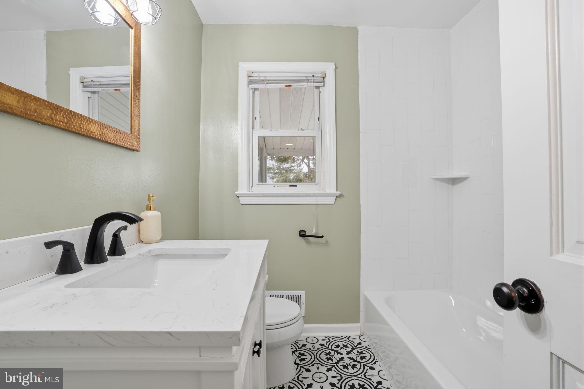 51 Unwin Drive Hamilton, NJ 08610 - Photo 27 of 32 a bathroom with a sink toilet and shower